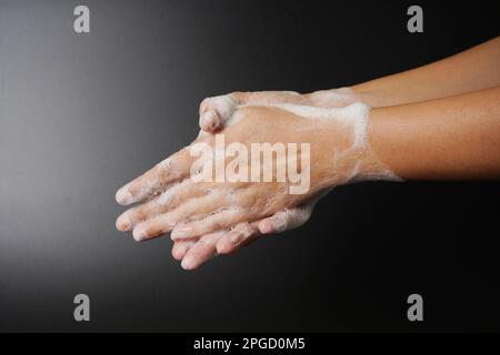 Washing hand on dark background Stock Photo