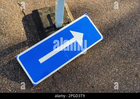 Turn right road sign lying on ground Stock Photo