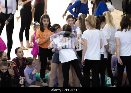 ODESSA, UKRAINE -MAR 5, 2023: Children's cheerleading championship. Young cheerleaders spectators and their parents emotionally watch performance of r Stock Photo