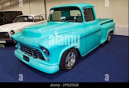 Three-quarters Front View of a Blue, 1957, Chevrolet 3100 Sidestep Pick-up Resto-mod, part of the 2023 London Classic Car Auction at Olympia Stock Photo