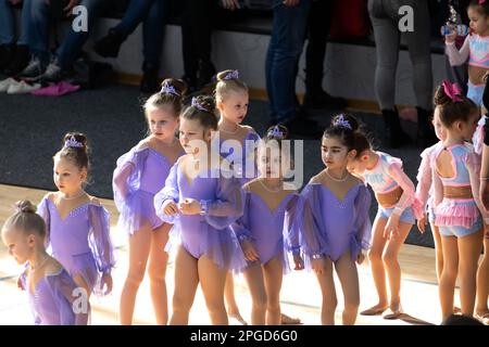 ODESSA, UKRAINE -MAR 5, 2023: Children's cheerleading championship. Young cheerleaders spectators and their parents emotionally watch performance of r Stock Photo