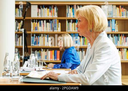 22 March 2023, North Rhine-Westphalia, Gütersloh: Brigitte Mohn (back), member of the Bertelsmann Stiftung Executive Board, speaks at the Bertelsmann Stiftung's annual press conference. Her mother Liz Mohn, President of the Liz Mohn Center, is seated in the foreground. Photo: Friso Gentsch/dpa Stock Photo