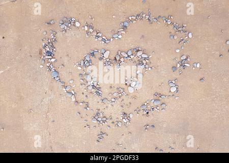 Pebble heart on sand. Love, valentine concept Stock Photo