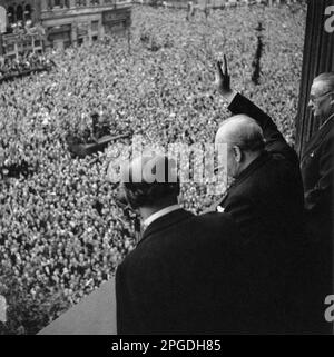 Winston Churchill waving to the crowds in Whitehall on VE day. 8th May 1945 Stock Photo