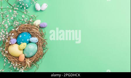 Easter banner on a green background. Bird's nest with Easter eggs. Happy Easter Stock Photo
