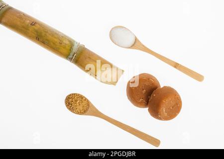 white sugar, brown sugar and sugar cane panela on white background Stock Photo