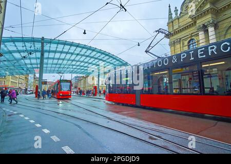 BERN, SWITZERLAND - MARCH 31, 2022: Modern trams run on Bubenbergplatz at Bahnhofplatz station, on March 31 in Bern, Switzerland Stock Photo