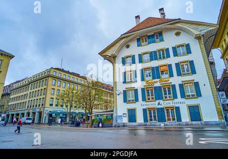 BERN, SWITZERLAND - MARCH 31, 2022: Bundesplatz square with medieval mansion with blue window shutters, on March 31 in Bern, Switzerland Stock Photo