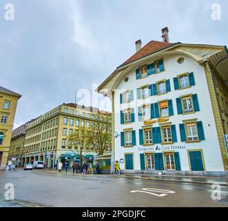 BERN, SWITZERLAND - MARCH 31, 2022: Scenic historic building on Bundesplatz with restaurant on ground floor, on March 31 in Bern, Switzerland Stock Photo