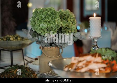 Bouquet of green Hydrangea flowers in pot on the table. Bouquet of flowers in vase on the table. Stock Photo