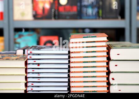 Books, notebooks, notepads lie on bookstore showcase, in library against background of shelves with book Stock Photo