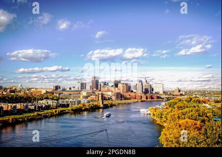 The Mississippi River flows through St. Paul Minnesota as fall colors pop on the riverbanks. Stock Photo