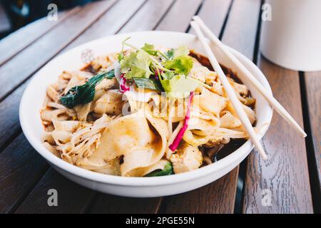 The most famous Chinese dish from Shaanxi province called biang biang noodles alternatively known as youpo chemian served with spicy chily oil chicken Stock Photo