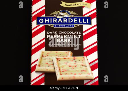 STILLWATER, MN, USA - DECEMBER 25, 2022: Ghiradelli Dark Chocolate Peppermint Bark candy bars and trademark logo. Stock Photo