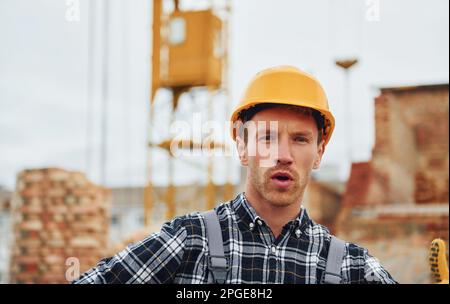 Portrait of construction worker in uniform and safety equipment Stock Photo
