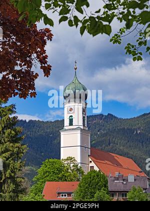 View of the tower of the Catholic parish church of St. Peter and Paul in Oberammergau, Bavaria, Germany Stock Photo