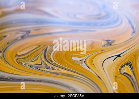 Colorful swirls of ochre paint. Abstract background. Stock Photo