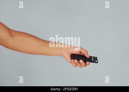 Close up view of man's hand that holding TV remote controller Stock Photo