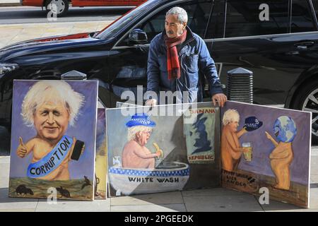 London, UK. 22nd Mar, 2023. Artist Kaya Mar, who often depicts Westminster politicians in his satirical work, stands outside Portcullis House with several of his paintings showing Boris Johnson and referencing the ongoing Partygate investigation, on day former Prime Minister Boris Johnson faces the House of Commons Privileges Committee over allegations he intentionally misled Parliament regarding the so called 'Partygate' gatherings. Credit: Imageplotter/Alamy Live News Stock Photo