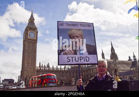 London, England, UK. 22nd Mar, 2023. Anti-Boris Johnson protesters gathered outside the parliament as the former Prime Minister faced questioning at the Partygate committee hearing. (Credit Image: © Vuk Valcic/ZUMA Press Wire) EDITORIAL USAGE ONLY! Not for Commercial USAGE! Credit: ZUMA Press, Inc./Alamy Live News Stock Photo