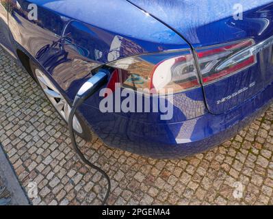 Blue Tesla model S charging Stock Photo
