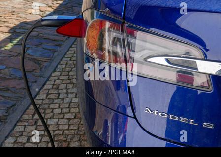 Blue Tesla model S charging Stock Photo