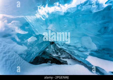 Beautiful natural ice cave in frozen lake on winter season Stock Photo