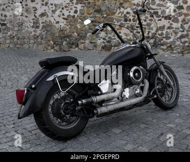 Black classic chopper motorcycle with chrome details. Stock Photo