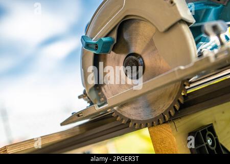 Circular Handheld Wood Saw Inside the Workshop Close Up. Construction Industry Power Tools. Stock Photo