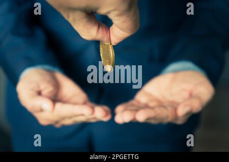 Businessman give money to partner. concept of charity. A businessman gives a gold coin to a businessman. Stock Photo