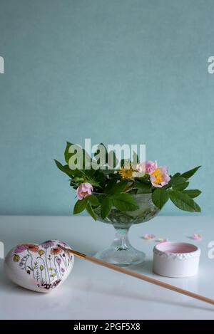 vase with flowers and artist studio equipment Stock Photo