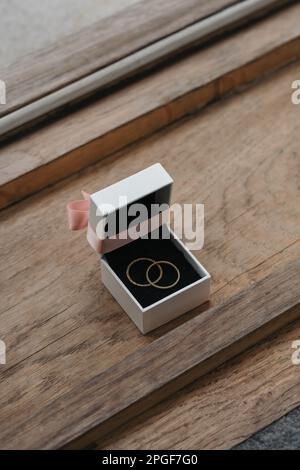 Golden wedding rings in ring box on wooden surface Stock Photo