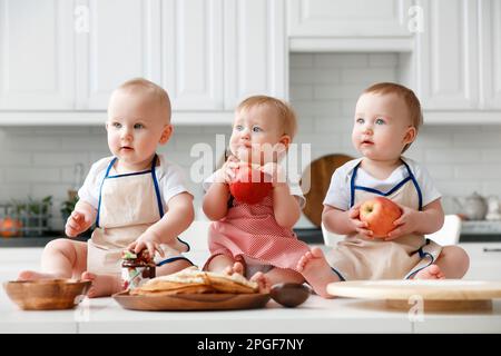 mockup of triplets in the kitchen with fruits and other products Stock Photo