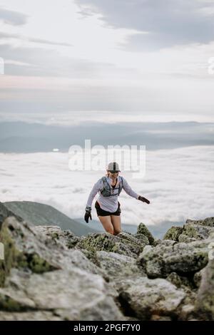 Woman hiking along Knife Edge Trail of Mount Katahdin Northeast