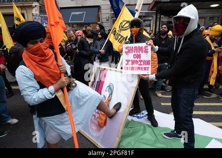 London, UK. 22 March, 2023. A demonstrator stamps on a portrait of PM Narendra Modi outside the Indian High Commission as Sikhs protest against rights