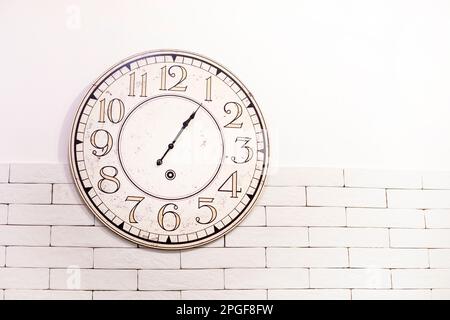 round wall clock on the wall. time translation, horizontal Stock Photo