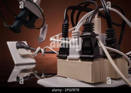 Electrical outlets overloaded beyond capacity Stock Photo