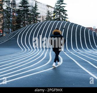 person walking between the lines of the Superkilen park Stock Photo