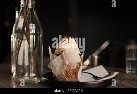 Frosted cupcake on a cafe table Stock Photo