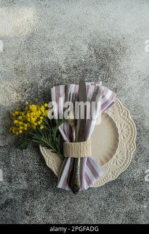Easte dinner set with yellow mimosa flowers Stock Photo