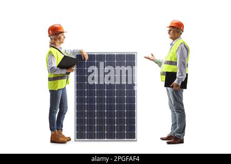Male and female engineers discussing a photovoltaic panel isolated on white background Stock Photo