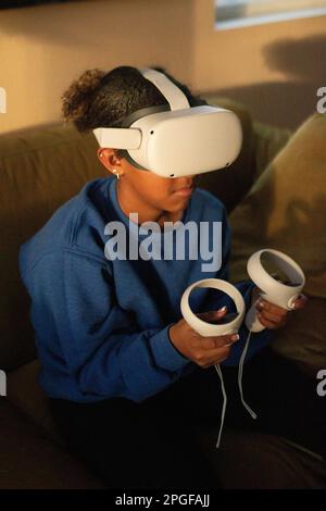 teenager playing virtual reality game Stock Photo