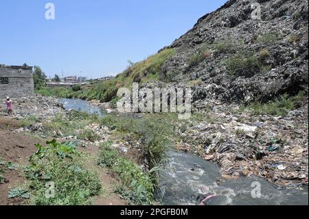 KENYA, Nairobi, Korogocho slum, Dandora waste dumping site, dirty water in sewer canal, plastic garbage / KENIA, Nairobi, Korogocho Slum, Dandora Müllkippe Stock Photo