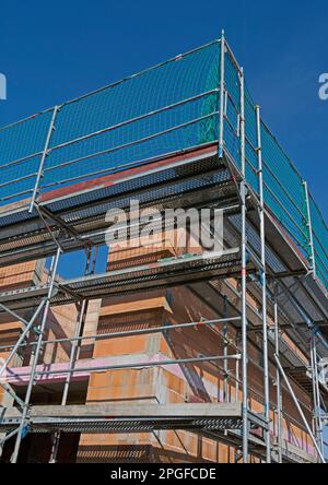 Massive home in shell construction with scaffolding, portrait format Stock Photo