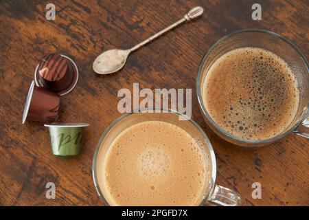 Cups of latte and black coffee with espresso capsules Stock Photo