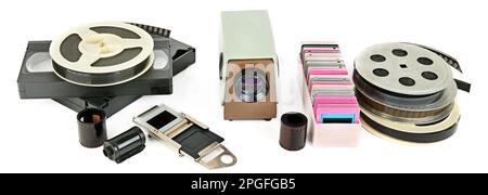 Old videocassettes and video projector with slides isolated on white background. Retro storage media. Wide photo Stock Photo