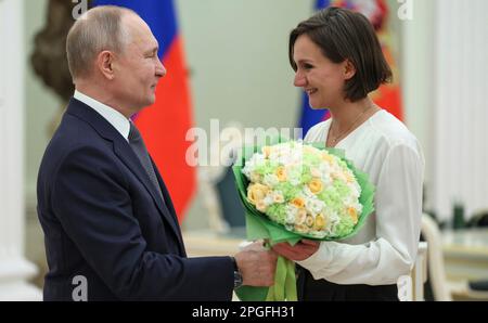 Moscow, Russia. 22nd Mar, 2023. Russian President Vladimir Putin congratulates Sculptor Ekaterina Pilnikova, right, after awarding her with the 2022 Presidential Prize for Young Culture Professionals at the Kremlin Palace, March 22, 2023 in Moscow, Russia. Credit: Gavriil Grigorov/Kremlin Pool/Alamy Live News Stock Photo