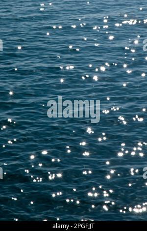Sunlight Sparkling on Ocean Surface Stock Photo