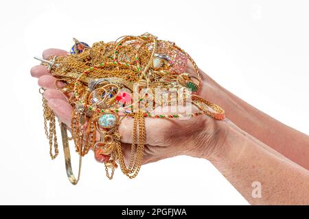 Horizontal shot of a two hands holding gold jewelry on a white background with copy space. Stock Photo