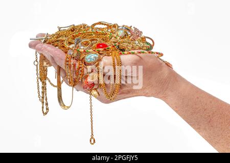 Horizontal shot of a handful of gold jewelry isolated on white. Stock Photo